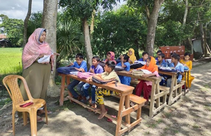 Teachers teaching students under trees in Barguna
