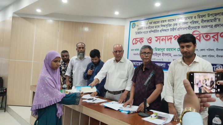 Distribution of Zila Parishad Education Scholarship Cheques, Certificates, and Wheelchairs in Nilpha Distribution of Zila Parishad Education Scholarship Cheques, Certificates, and Wheelchairs in Nilpha