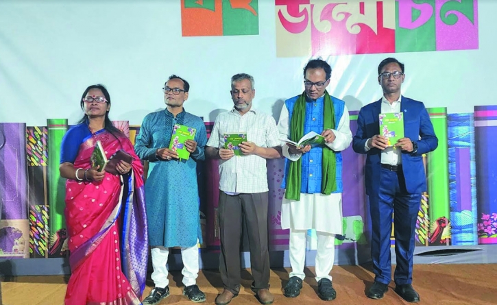 Journalist Deepak Acharjee opens book cover of novel, “Sesh Mohonay” at Ekushe Book Fair